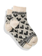 Cream knit socks with black Fair Isle heart pattern. Solid cream cuffs, heels, and toes.