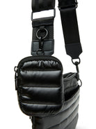 Black quilted crossbody bag with black adjustable strap and hardware.  Small zippered front pocket.