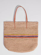Beige woven tote bag with light orange leather handles and a multicolored stripe detail.