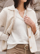 Brown suede studded belt with a gold oval buckle.