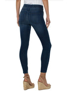 Dark wash denim pull-on jeans with pockets; rear view.