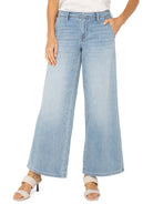 Light blue, wide-leg jeans;  model wears light beige heels.