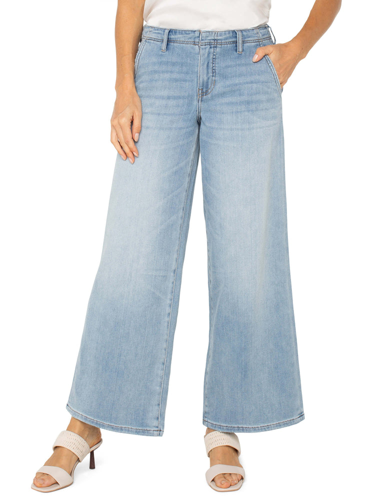 Light blue, wide-leg jeans;  model wears light beige heels.