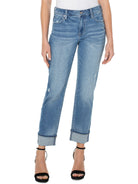 Light wash blue rolled-cuff jeans with distressed details.  Mid-rise fit.