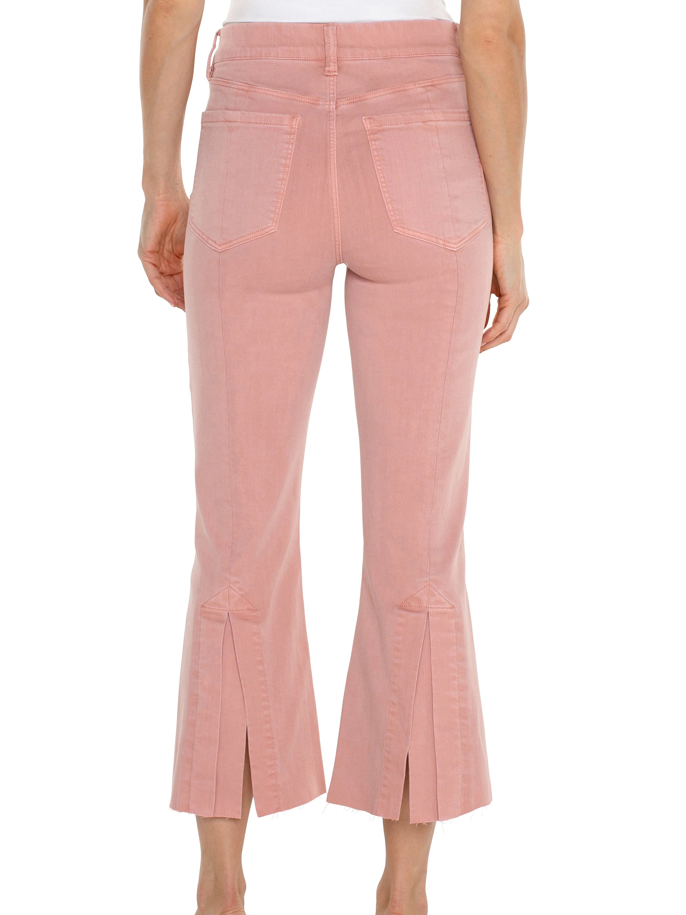 Dusty rose cropped flare jeans; back view showing center seam and front pockets. Raw hem.