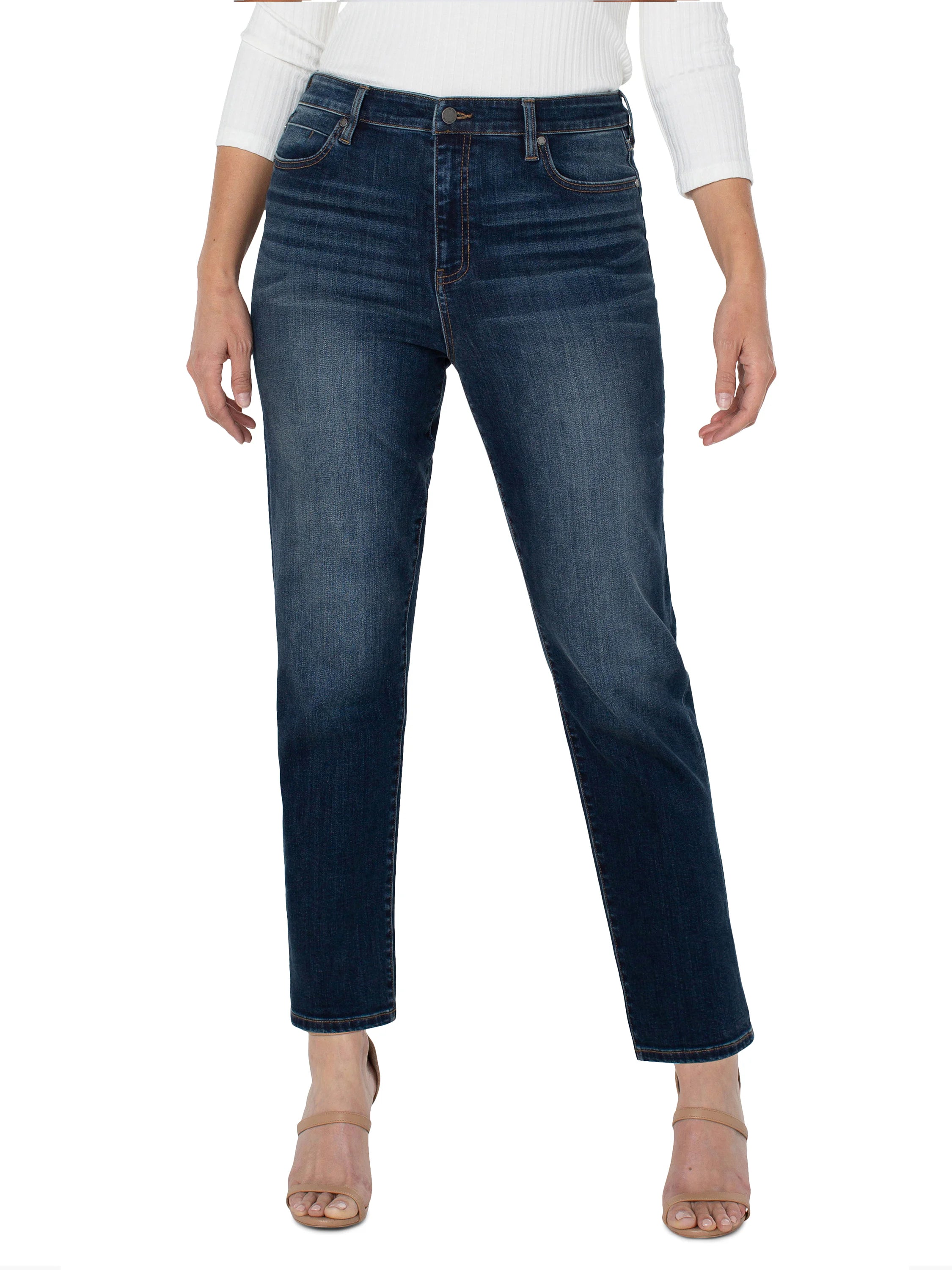 Dark wash straight-leg jeans; mid-rise waist.  Visible stitching.  Model wears neutral-toned sandals.