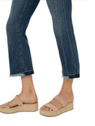 Mid-rise, cropped, dark-wash jeans with frayed hems.  Model wears them with light beige platform sandals.