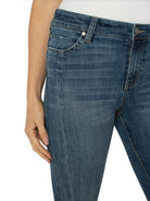Mid-rise, cropped, flared jeans in medium-wash blue denim with visible stitching and a front pocket.
