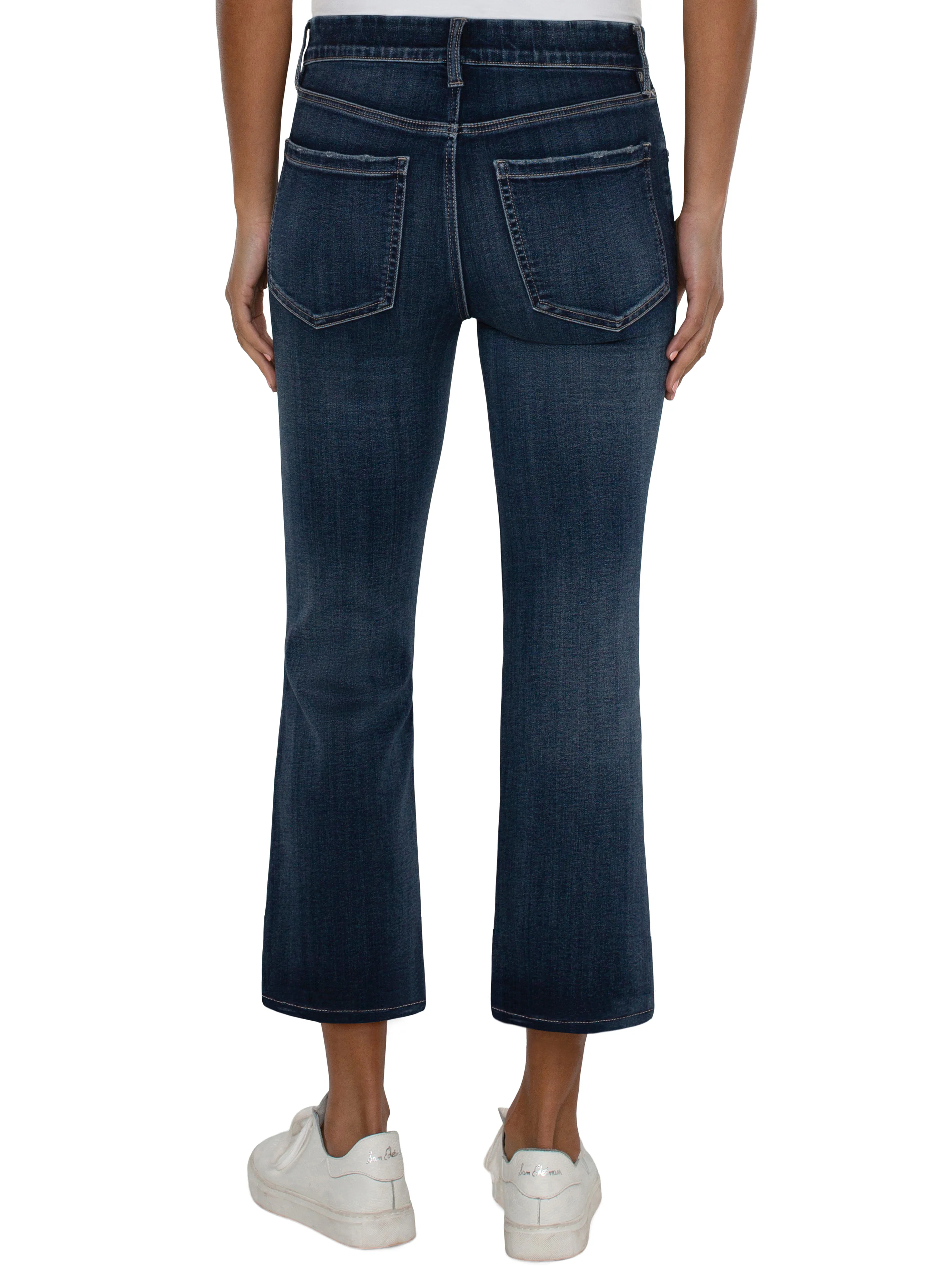 Dark wash blue cropped flare jeans, shown from the back.  Features back pockets.