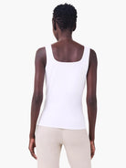 White jersey tank, back view on model. Square neckline and fitted silhouette.
