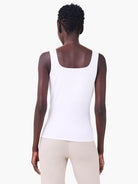 White jersey tank top with square back neckline, worn by a model facing away.