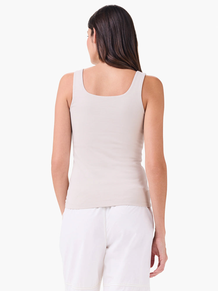 Light taupe fitted tank top with a square back neckline, shown on a woman from behind.
