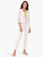 Bright lime green sleeveless tank top with a wide U-neck, partially visible under an open jacket.