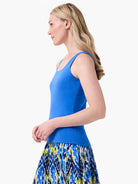Bright blue sleeveless tank top with a scoop neck, worn by a model.