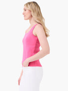 Bright pink scoop neck tank top on a model, sleeveless and fitted.