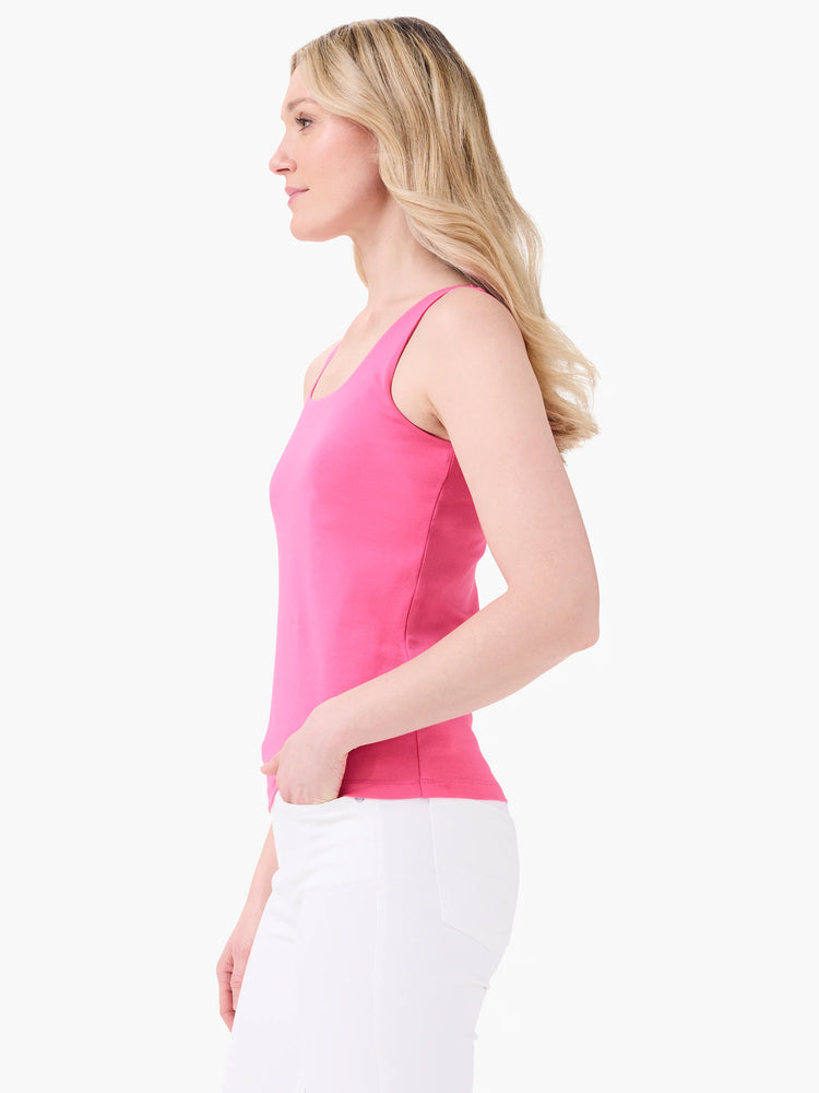 Bright pink scoop neck tank top on a model, sleeveless and fitted.