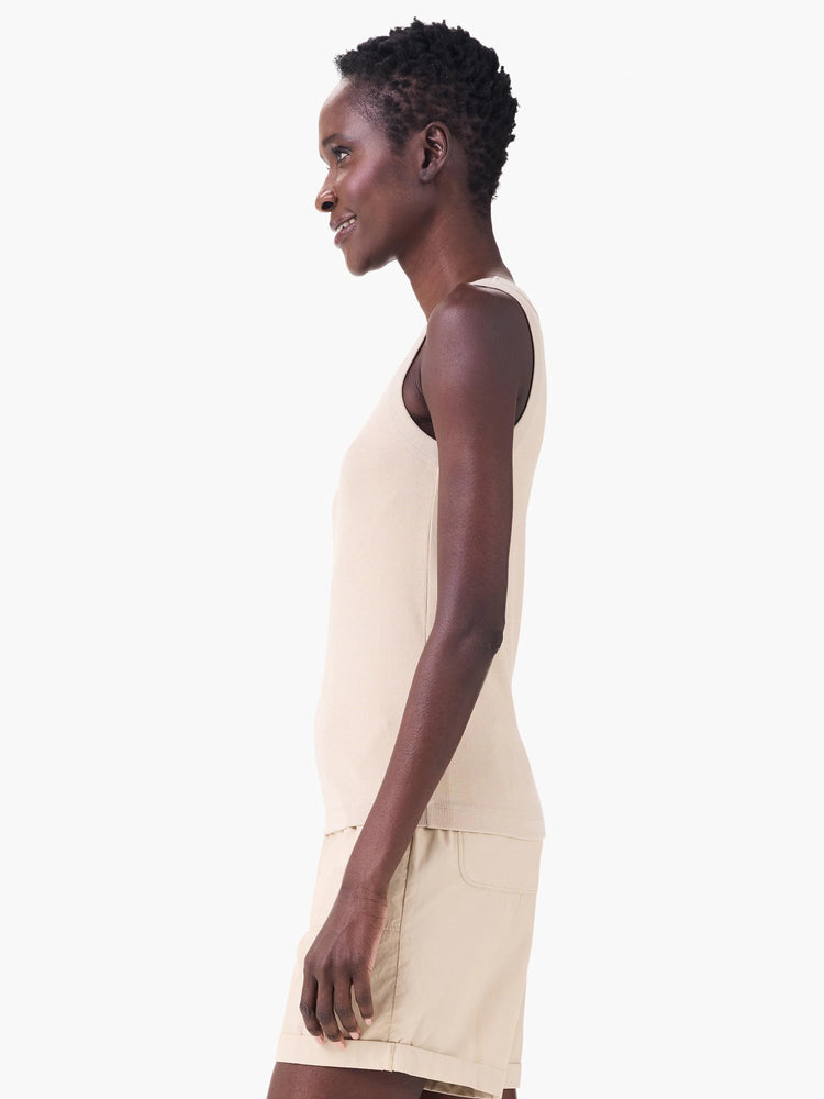 Light beige ribbed scoop neck tank top worn by a model in a side profile.