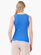 Fitted blue ribbed tank with a scoop back neckline, showing vertical knit texture.