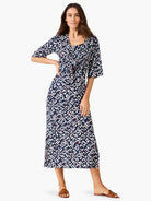 Dark blue geometric pattern cardigan with white, pink, & orange shapes, tied at waist, V-neck, elbow sleeves, midi length.