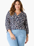 Top features indigo, white, pink, and orange geometric pattern, V-neck with ties, and 3/4 sleeves.