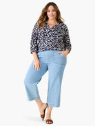 Indigo top with white, pink, and orange angular geometric print. Features V-neck with ties and 3/4 sleeves.