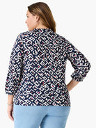 Indigo top with white, pink, orange geometric angular pattern, 3/4 sleeves with elastic cuffs, and shirred back.