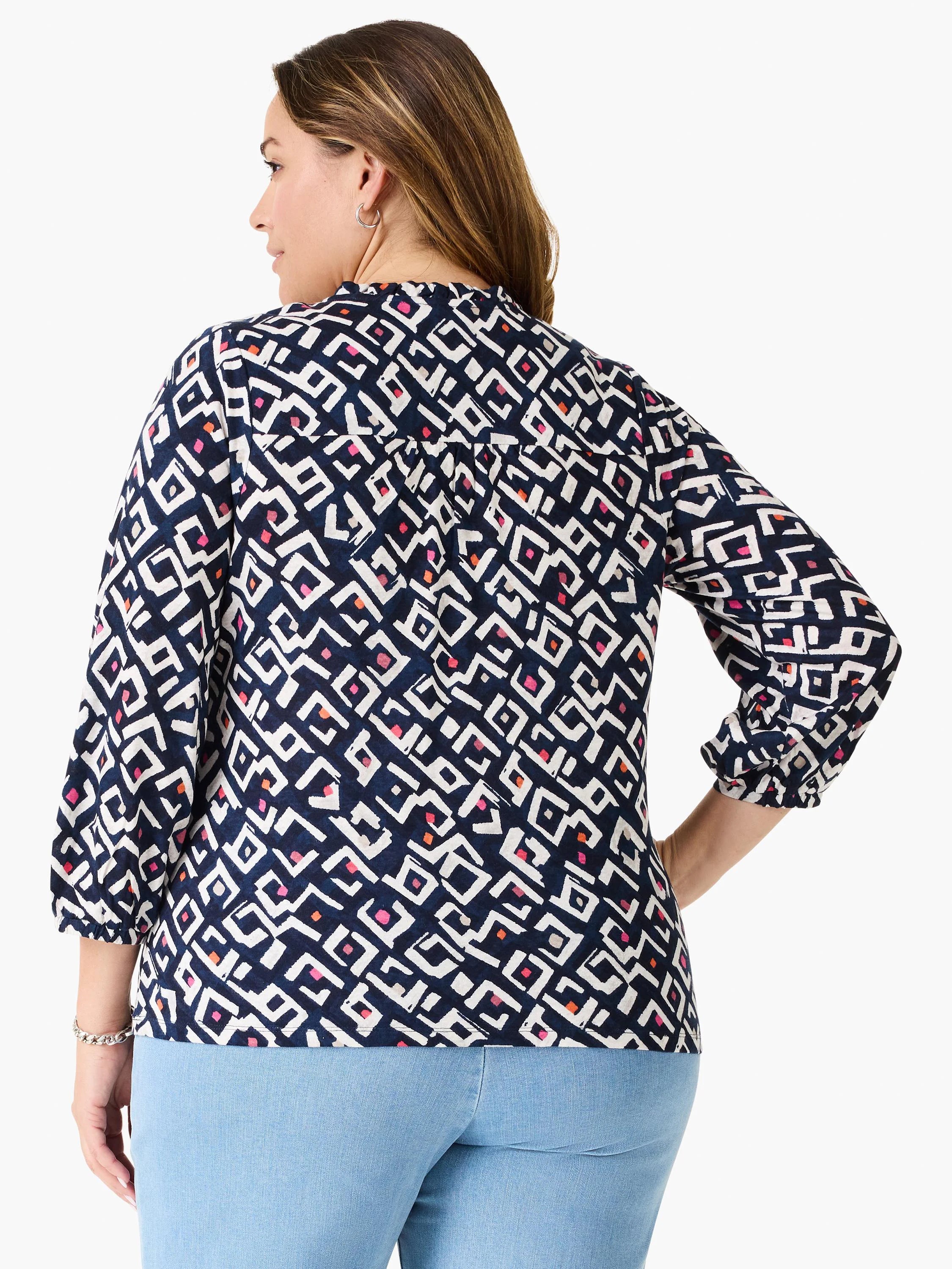 Indigo top with white, pink, orange geometric angular pattern, 3/4 sleeves with elastic cuffs, and shirred back.