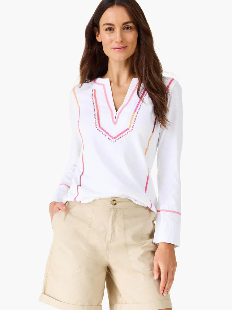 White V-neck long-sleeve top with geometric pink, orange, and dark red embroidery on the neckline and sleeves.