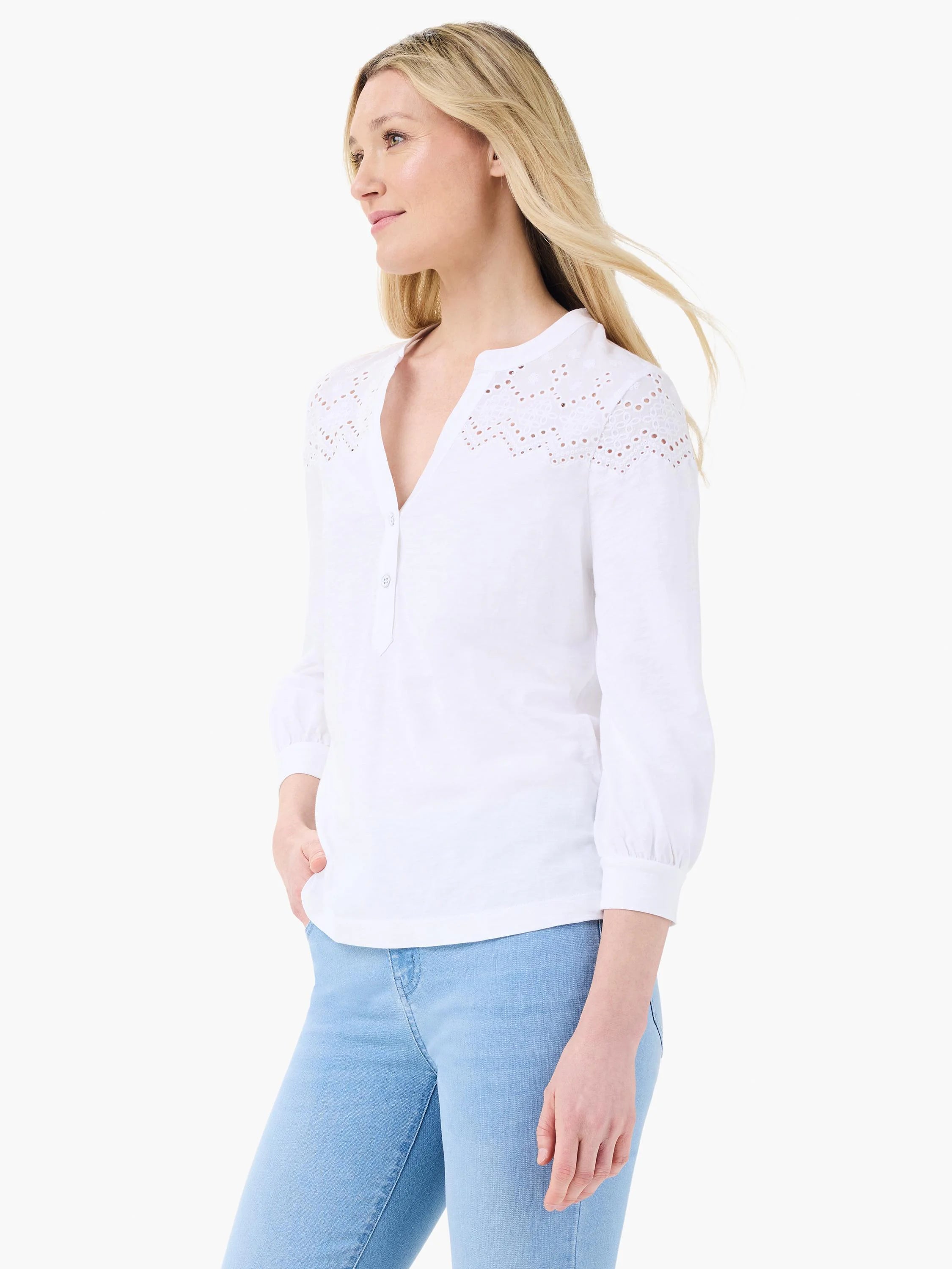 White mixed media top with eyelet lace yoke, 3/4 sleeves, and buttoned Henley neck.