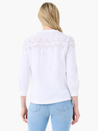 White top with eyelet lace back yoke and 3/4 gathered sleeves.