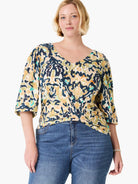 V-neck top with cream, navy, olive, yellow, and teal abstract pattern. 3/4 sleeves.