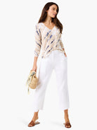 V-neck sweater in beige with white and navy blue tie-dye pattern.