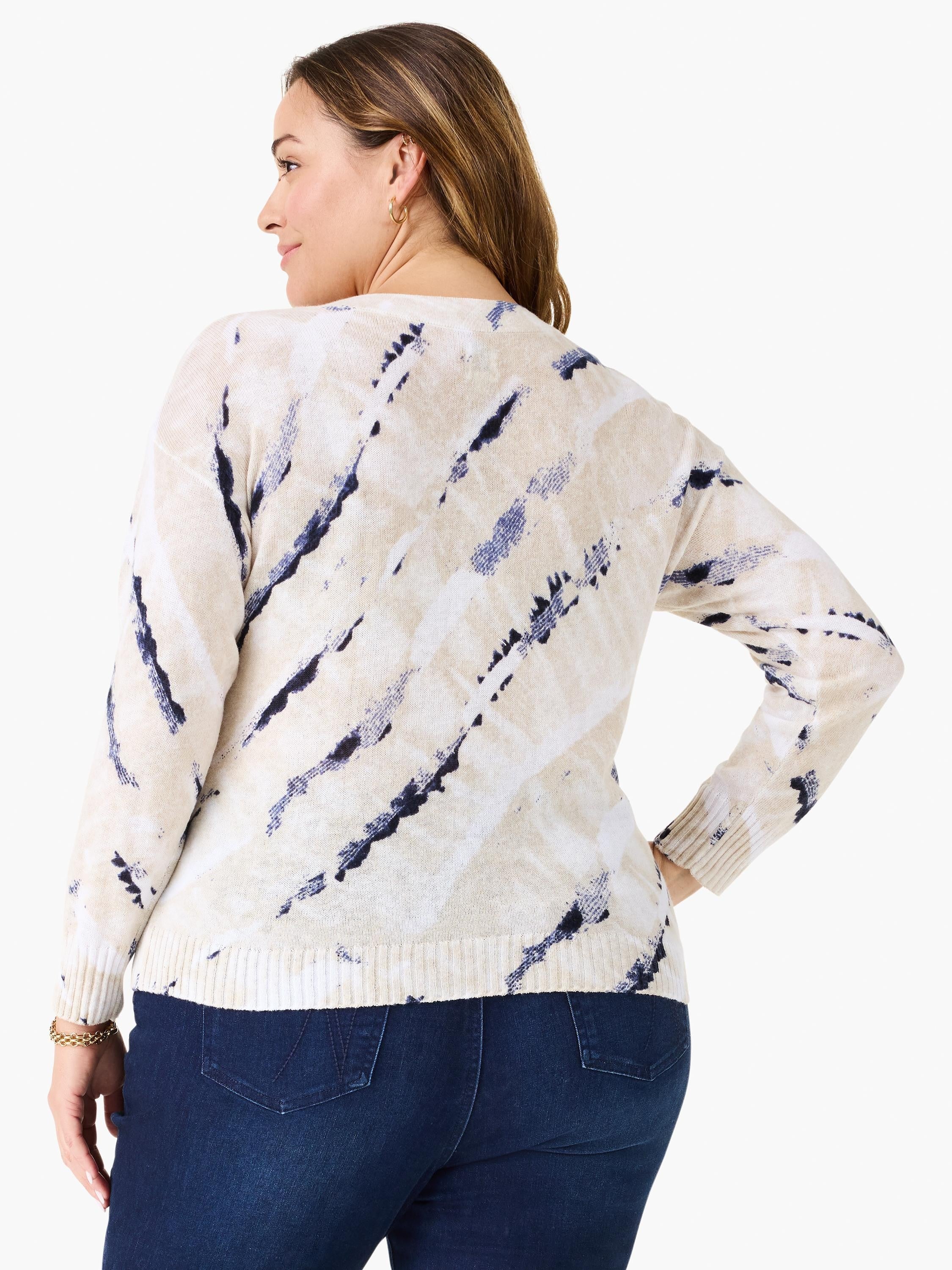 Cream sweater with irregular navy blue abstract streaks, ribbed cuffs & hem. Shown from the back.
