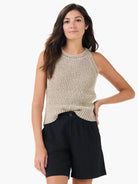 Beige tape yarn high neck tank with vertical knit texture and an open-knit neckline detail.
