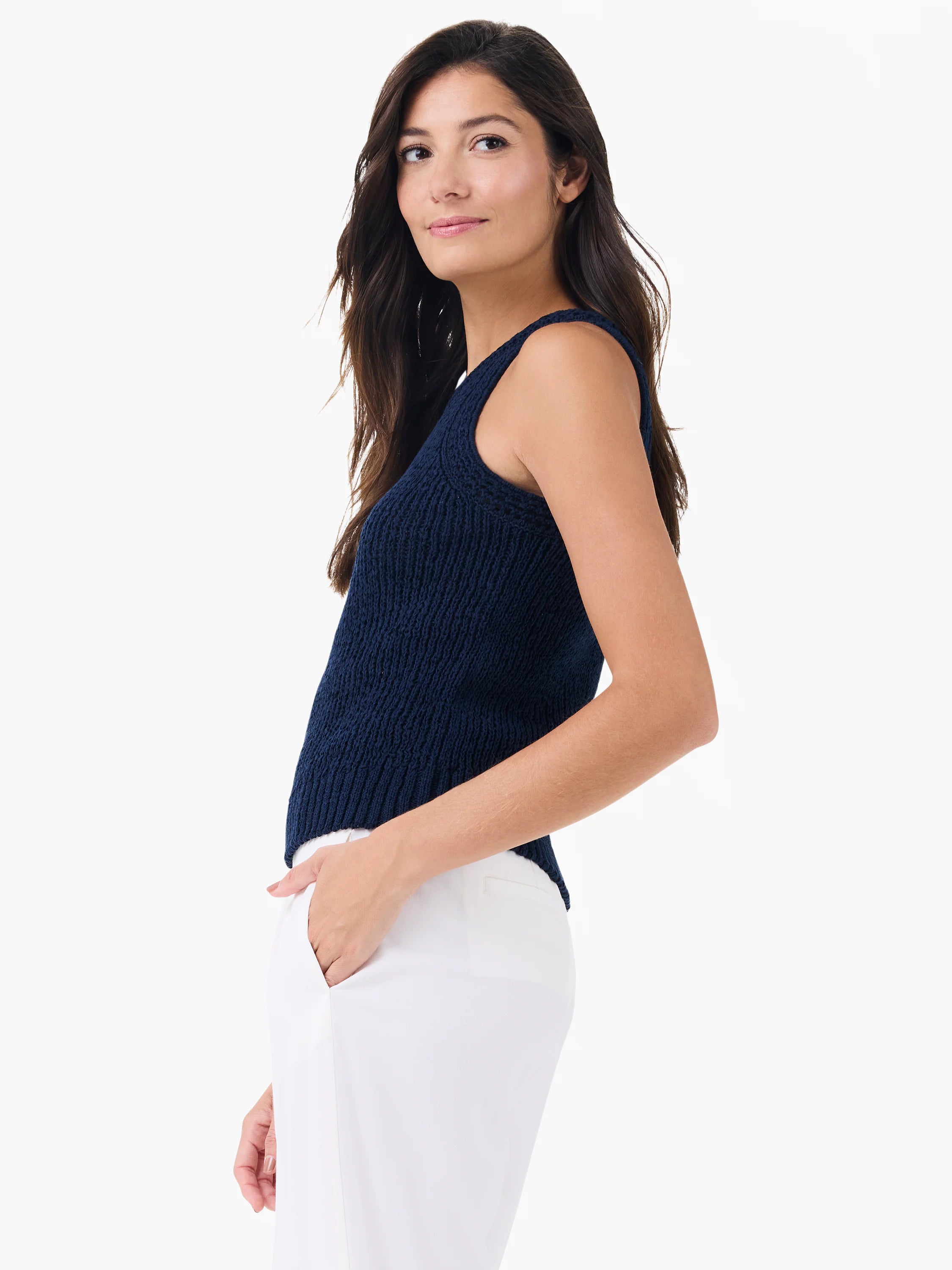 Navy high neck tank top with a visible ribbed knit texture, modeled with white pants.