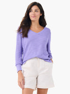 Lavender V-neck sweater with a subtle breezy texture and long sleeves.