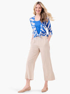 Blue and white patterned cardigan with an abstract design, tied at the front.