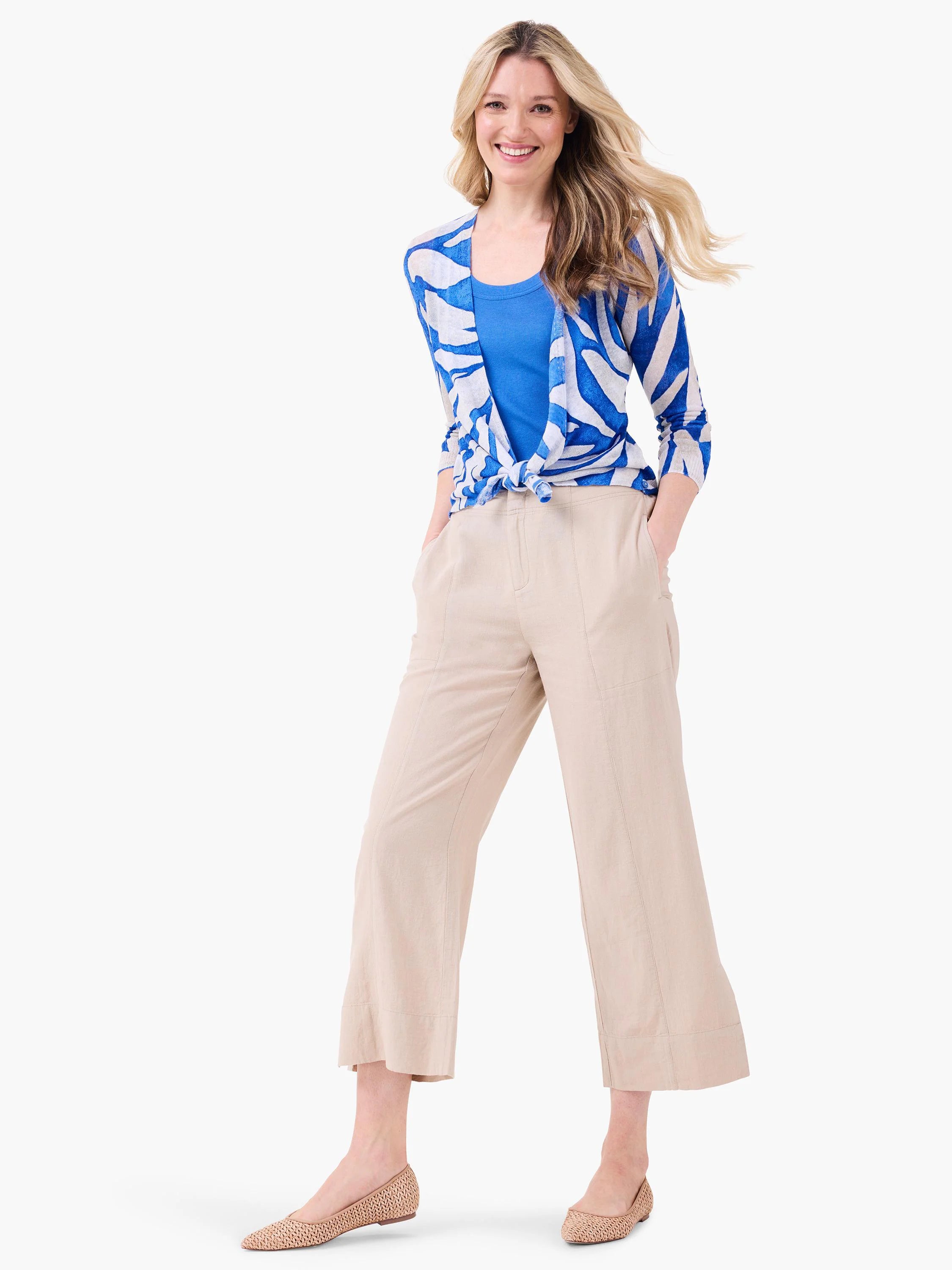 Blue and white patterned cardigan with an abstract design, tied at the front.