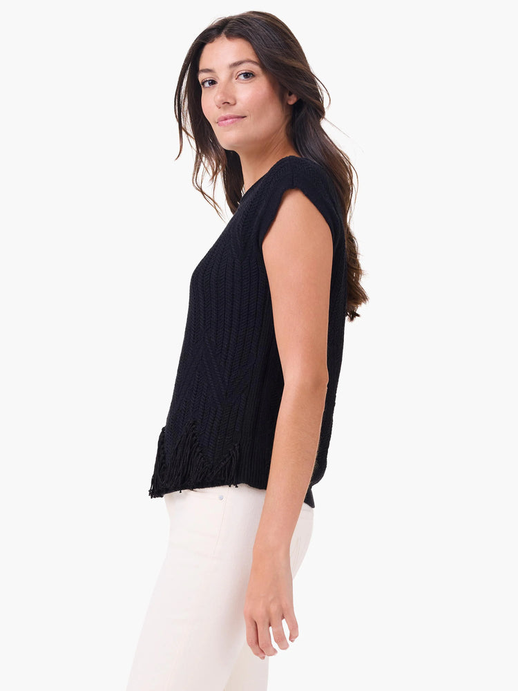 Black sleeveless sweater features a chevron knit texture and fringe hem.