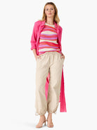 Knit tank top with wavy horizontal stripes in cream, fuchsia, orange, and purple.