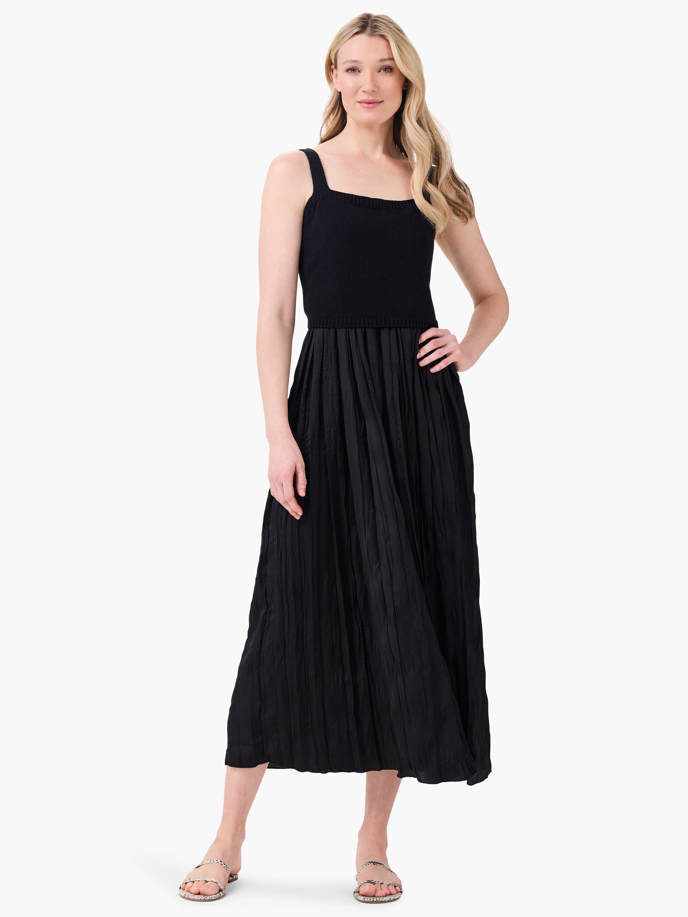 Black Kara dress with square neck, wide straps, ribbed knit bodice, and a crinkled pleated midi skirt.
