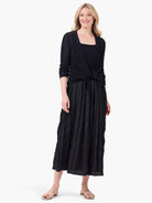 Black Kara Dress. Features a square neckline and a long, crinkled skirt.