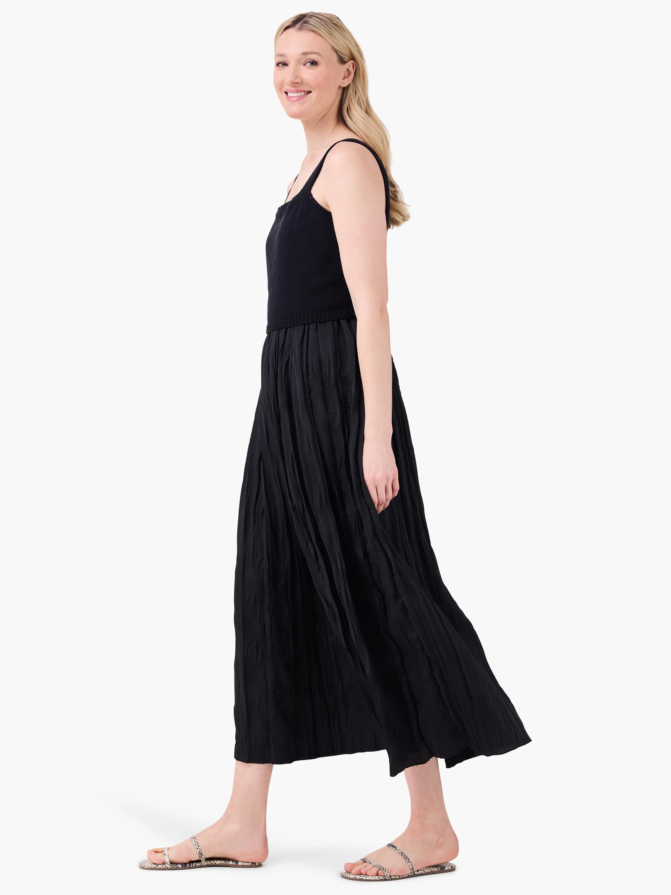 Black Kara Dress with knit bodice, wide straps, and a flowy, crinkled maxi skirt.