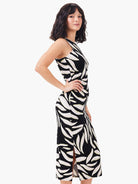 Sleeveless black maxi dress with off-white leaf print & subtle yellow details. Fitted silhouette, side slit.