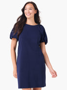 Navy blue t-shirt dress with short, puffed sleeves and delicate eyelet details.