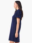 Navy blue T-shirt dress, above-knee length, with puffed sleeves featuring geometric cut-outs.