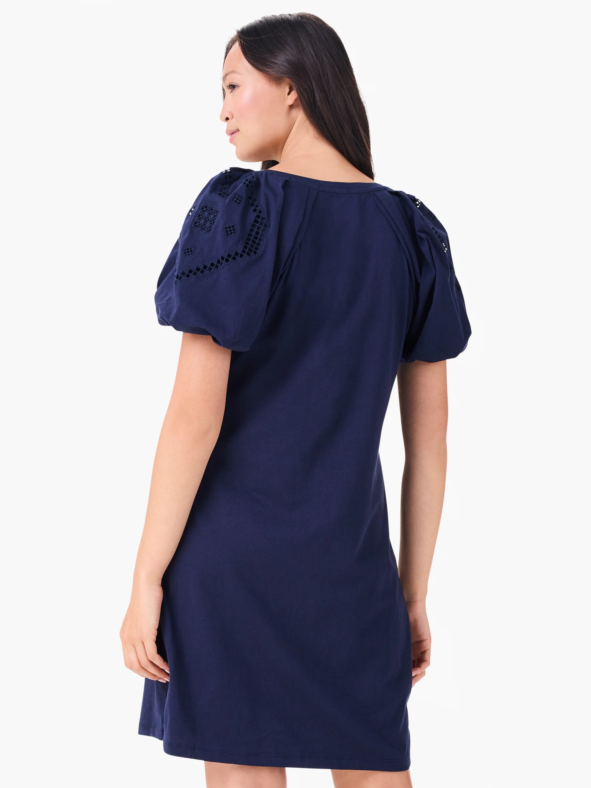 Navy blue T-shirt dress with puffed short sleeves, detailed with geometric eyelet cut-outs.