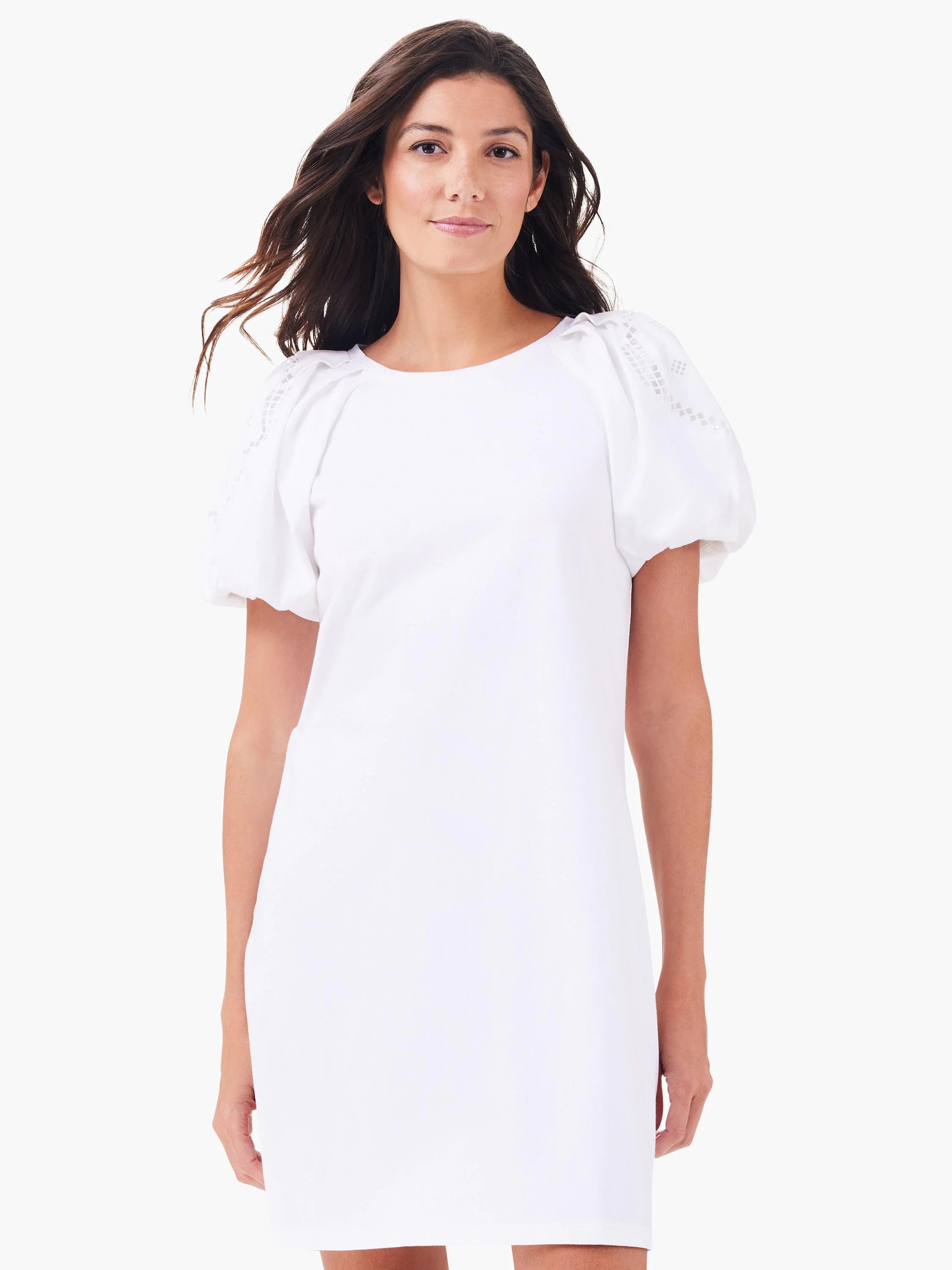 White t-shirt dress with short puffed sleeves featuring a cutout lattice pattern on shoulders. Round neck.