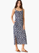Indigo midi dress with angular white, pink, orange pattern. Spaghetti straps, square neck, pockets, side slit.
