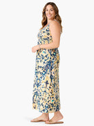 Sleeveless maxi dress with abstract print in cream, navy, golden yellow, and teal. Relaxed silhouette.